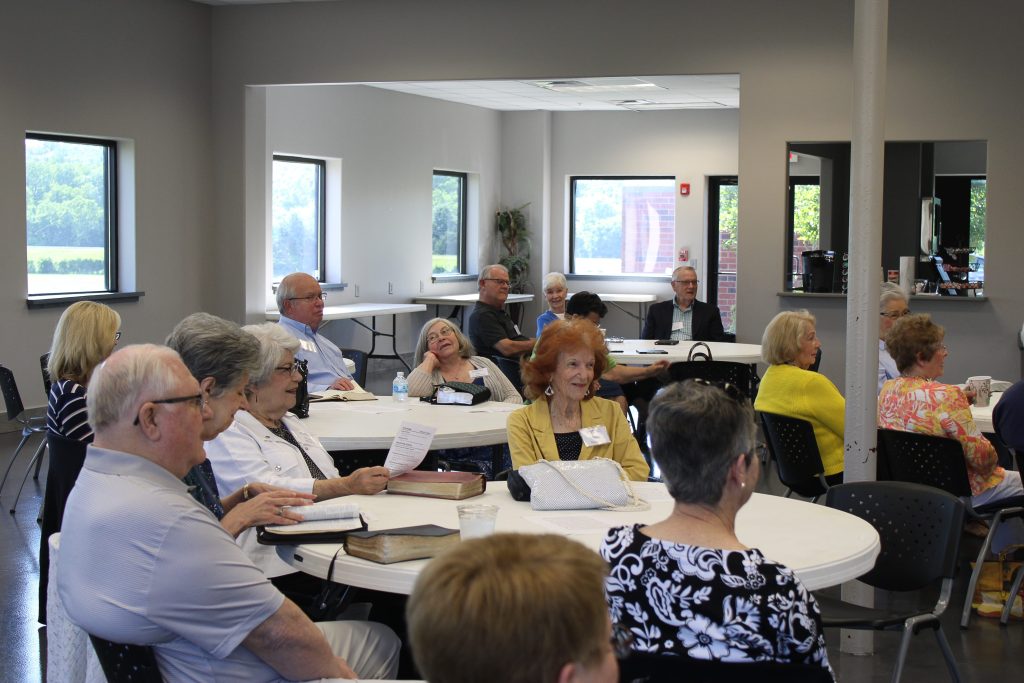 Senior adults gathered around tables for a Senior Adult Ministry meeting at Community Baptist Church