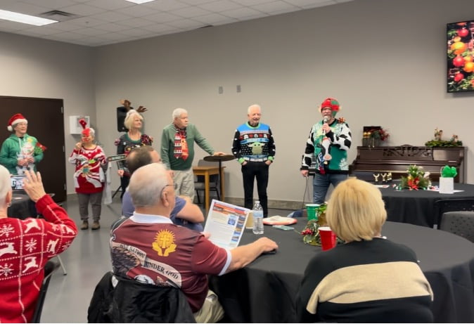 Senior adults enjoying a Christmas-themed monthly lunch together