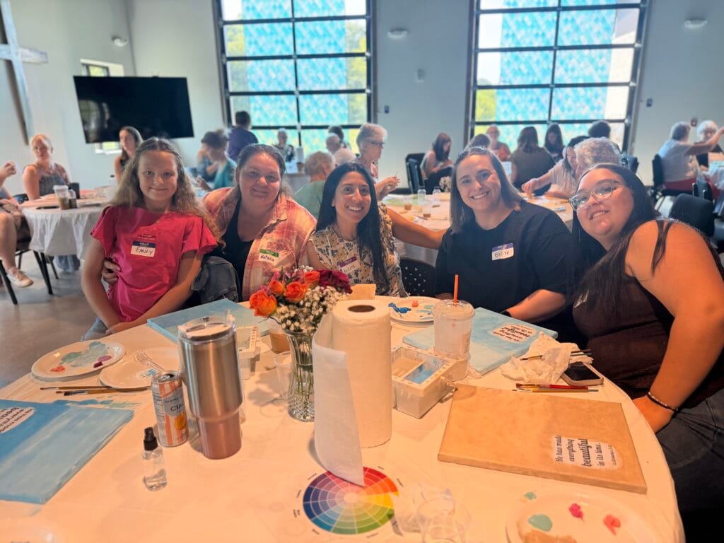 Women of Community Baptist Church gathered around a table at a Women's Ministry event